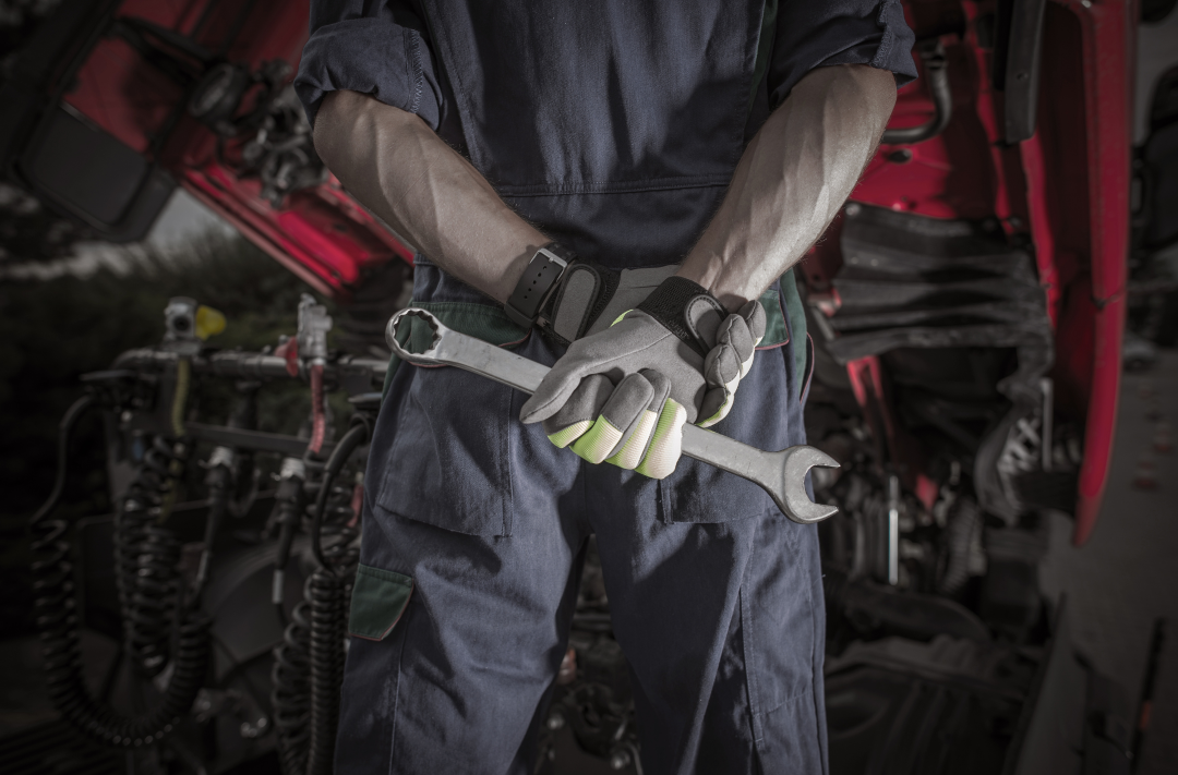 Auto electrical diagnostics technician working on a vehicle